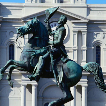 The statue in front of the grand St Louis Cathedral, built in 1794, at one end of Jackson Square in the French Quarter - New Orleans, Louisiana