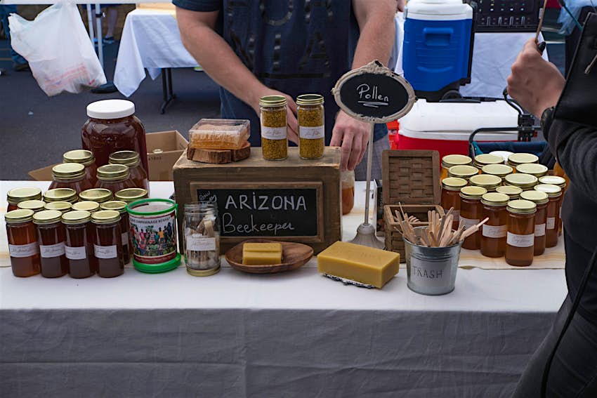 PHOENIX, ARIZONA - NOVEMBER 25 2017 - Arizona Beekeeper raw honey booth at the Phoenix Public Market held every Saturday morning. PHOENIX, ARIZONA - NOVEMBER 25 2017 - Arizona Beekeeper raw honey booth at the Phoenix Public Market held every Saturday morning.