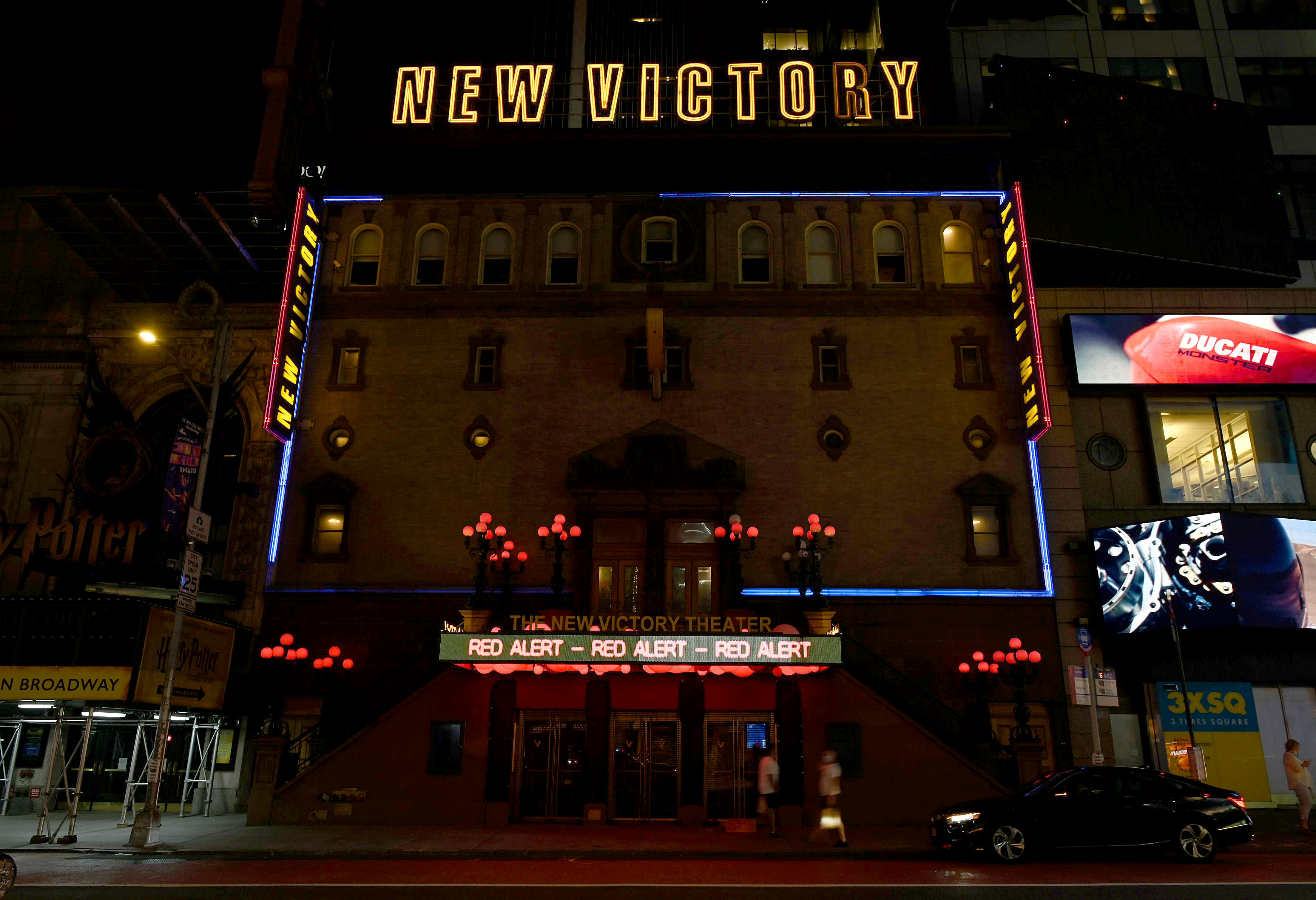 New Victory Theater in New York City is lite up at night 