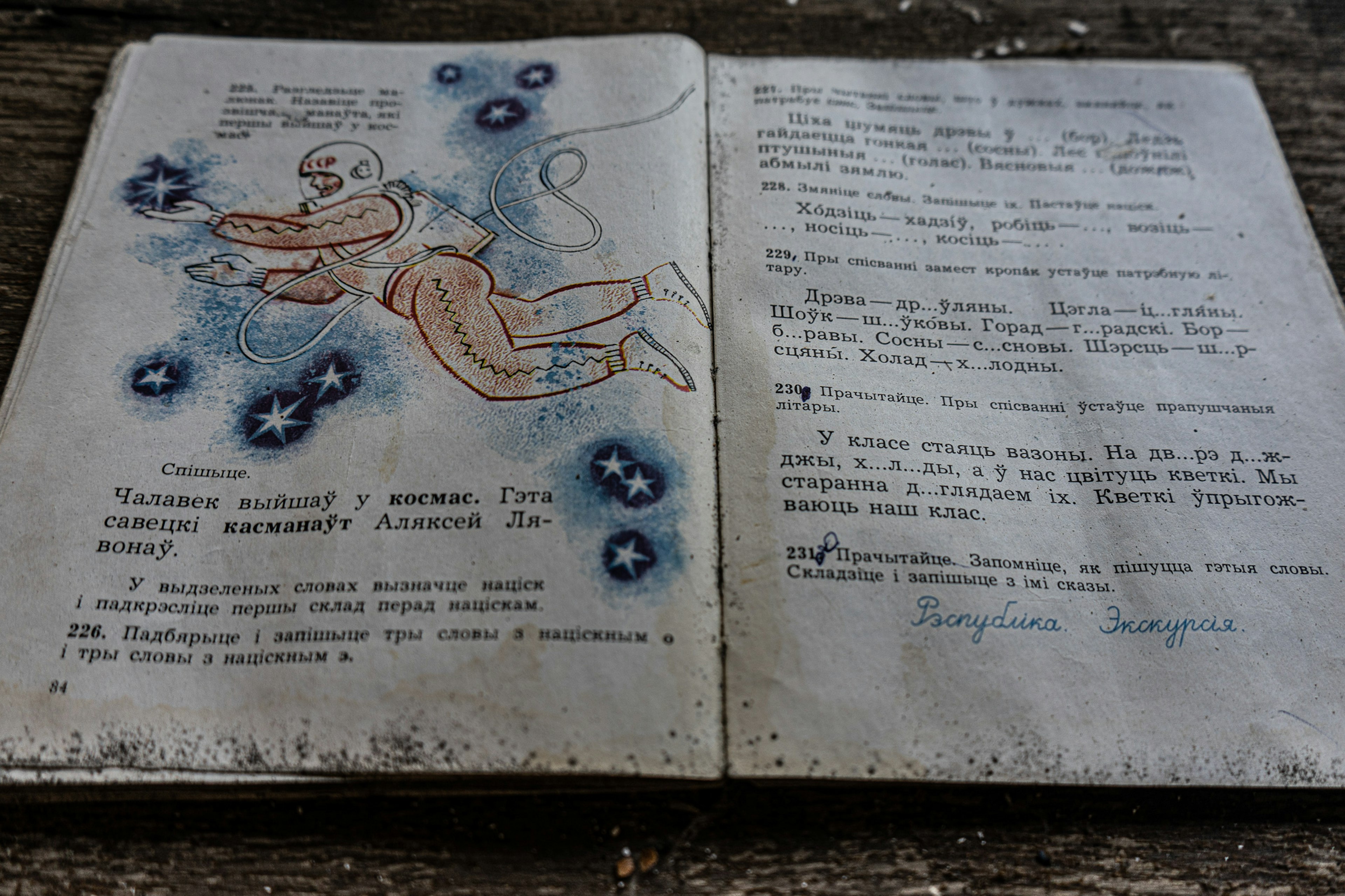 A child's school book in an abandoned school near Chernobyl shows an astronaut.