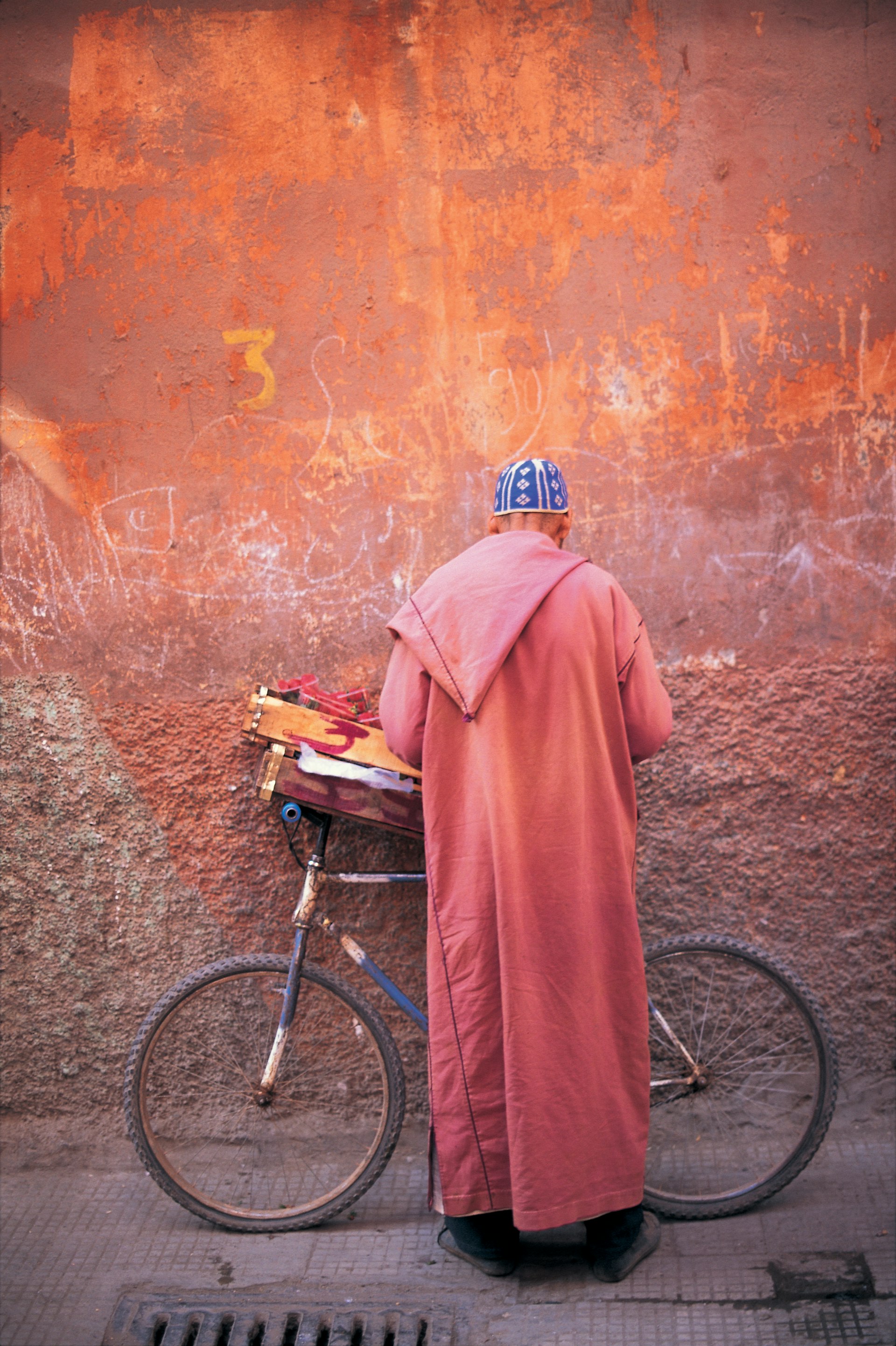 Man with a bicycle in the medina in Marrakesh, Morocco