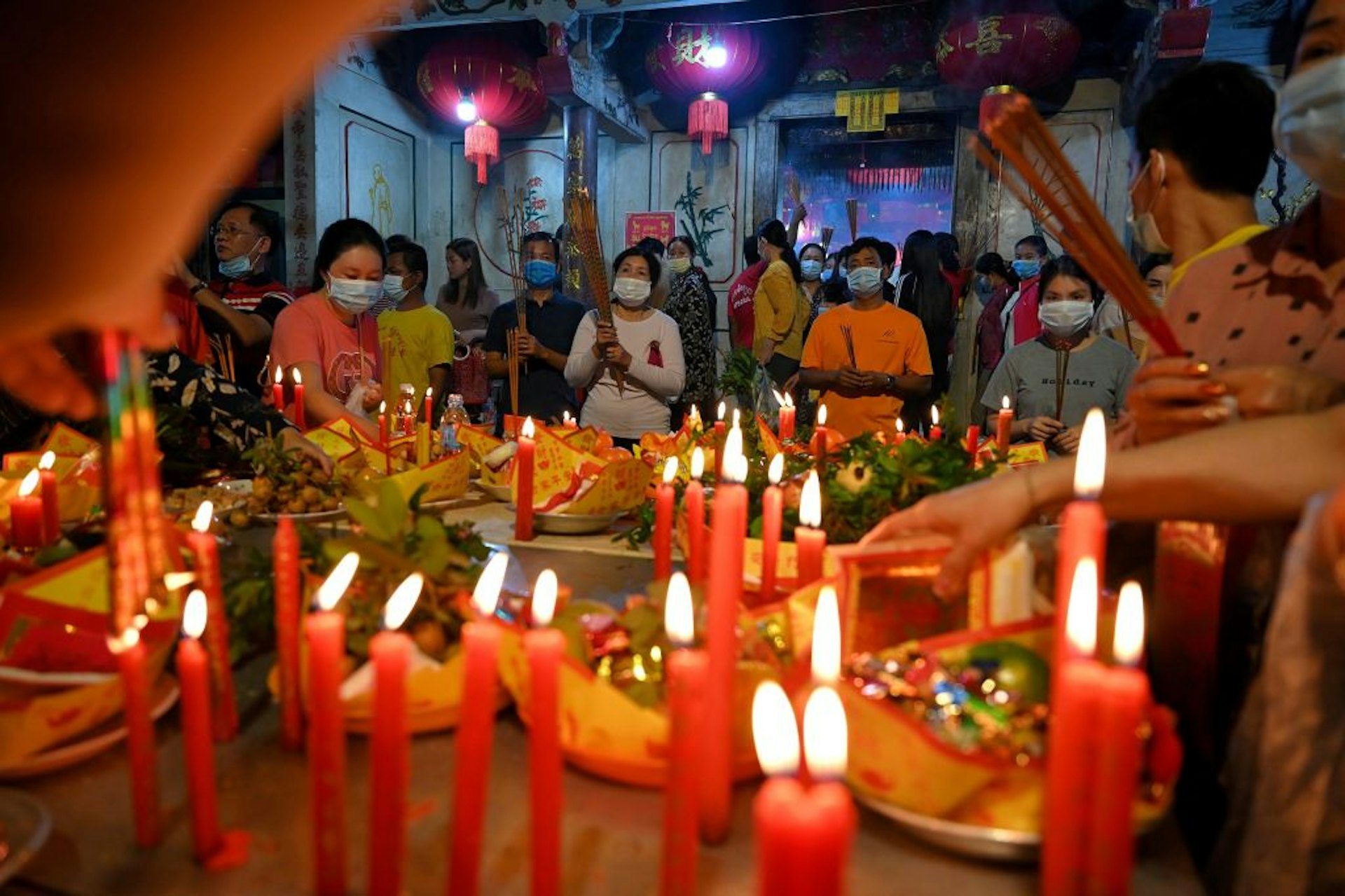 Devotees pray at a temple to mark the start of the Lunar New Year in Ta Khmao, Kandal province on February 12, 2021.