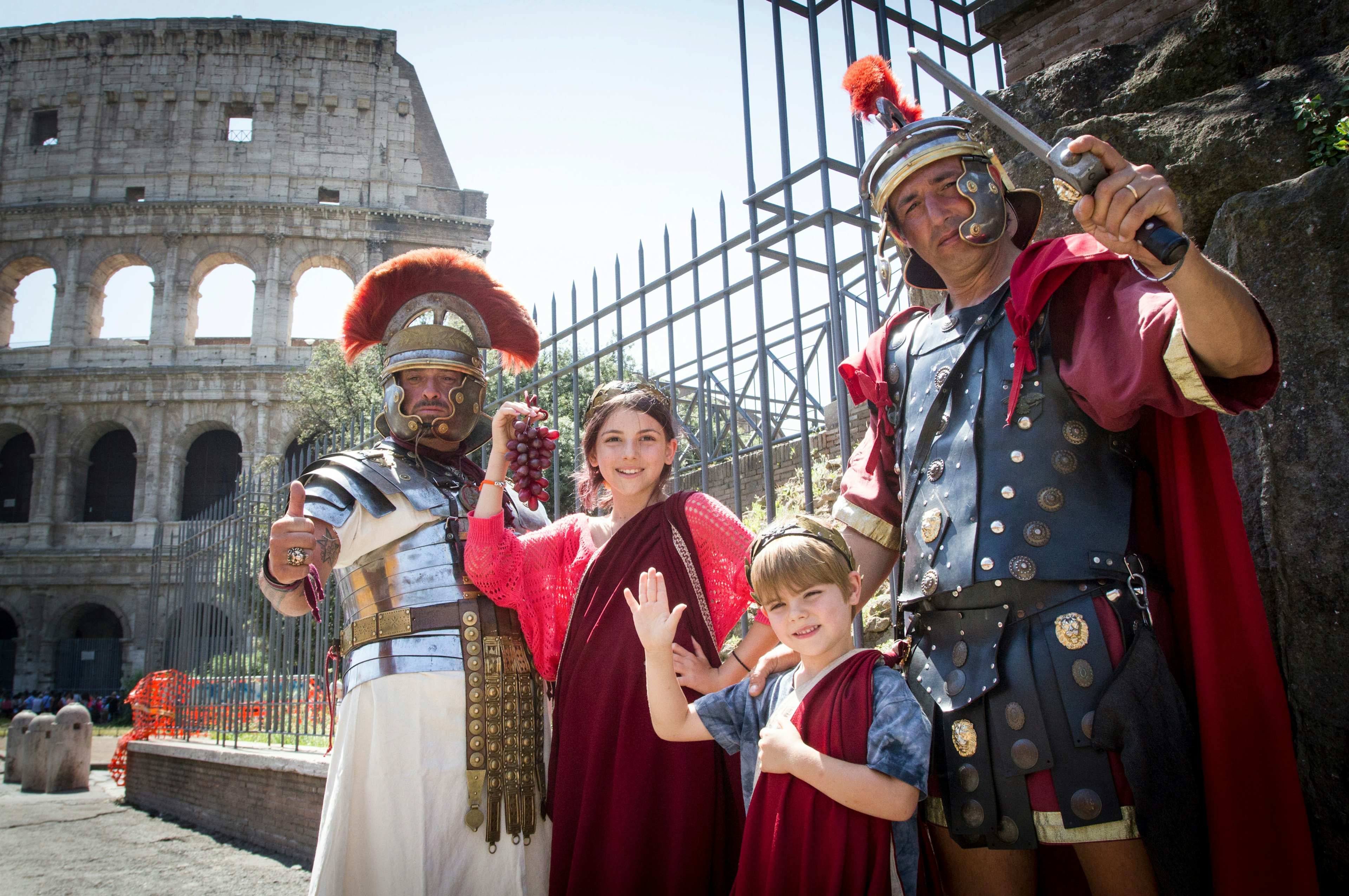 June 20, 2013: Two kids dressed like ancient Romans, pose with two centurion impersonators outside the Colosseum.