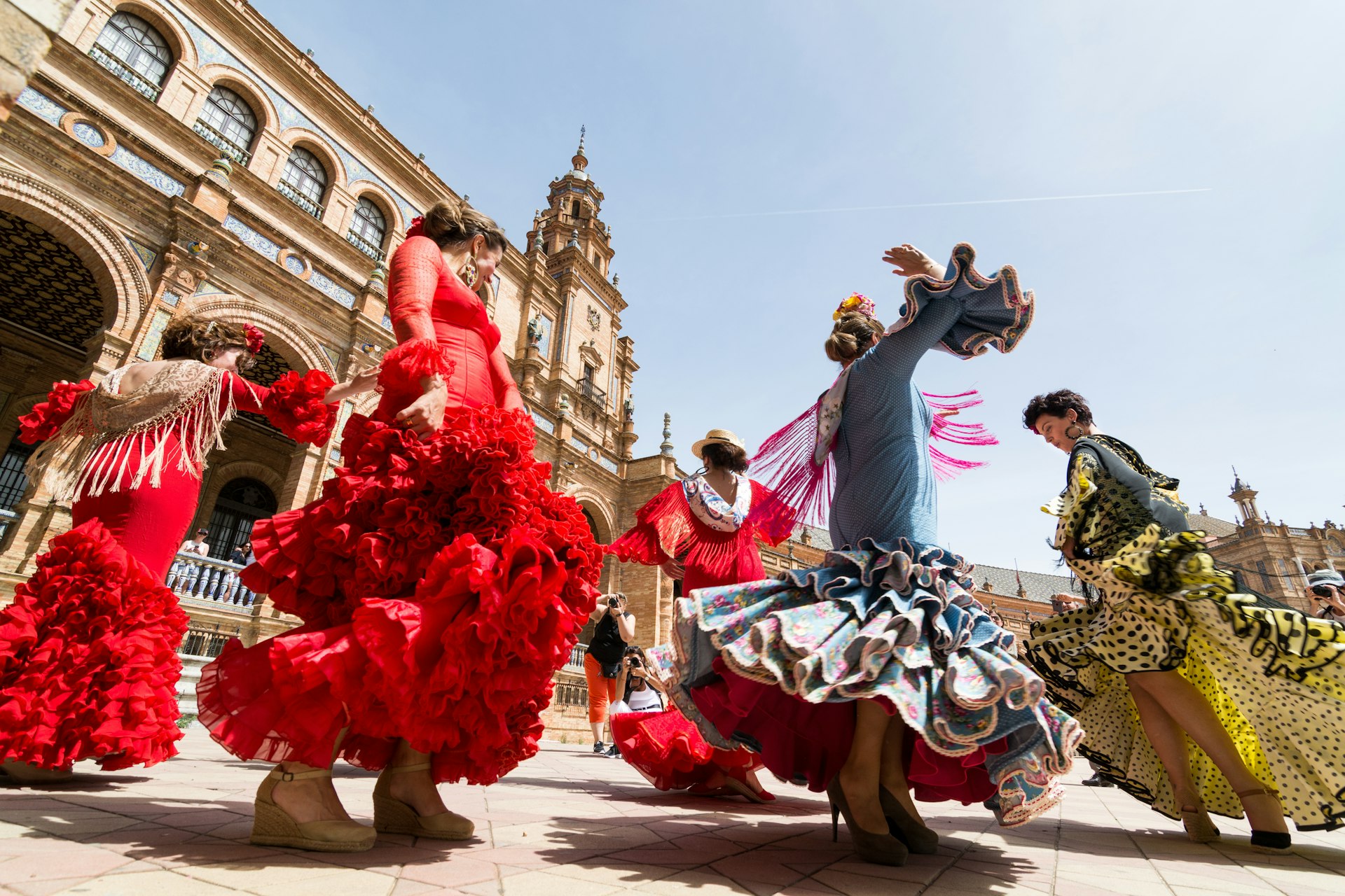 Young women dance the flamenco on the Plaza de Espana. 