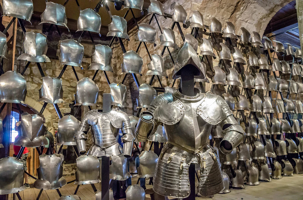 A wall of metal armor with one standing figure in full armor in the foreground