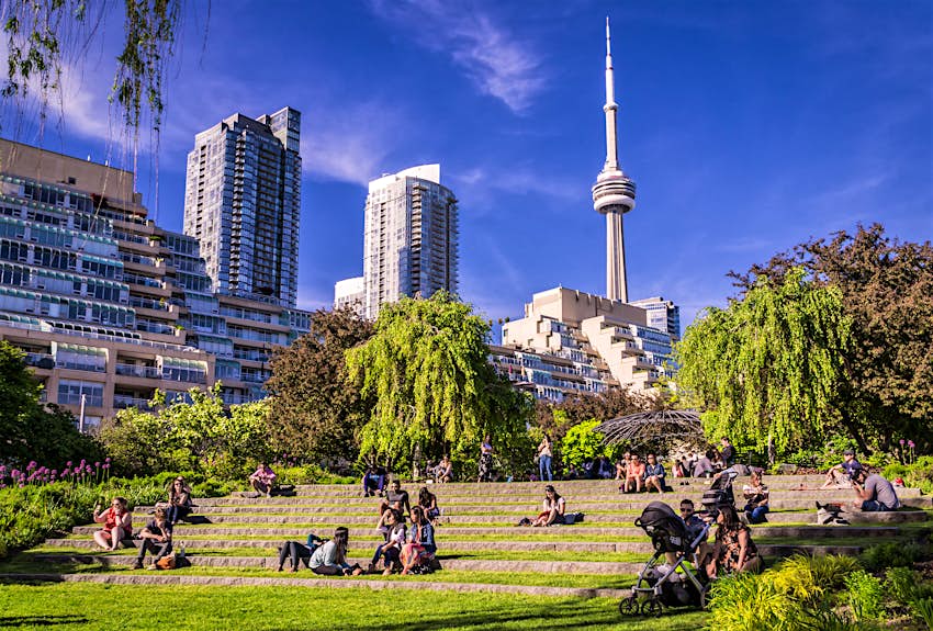 Visitors seated in the Toronto Music Garden on a sunny day