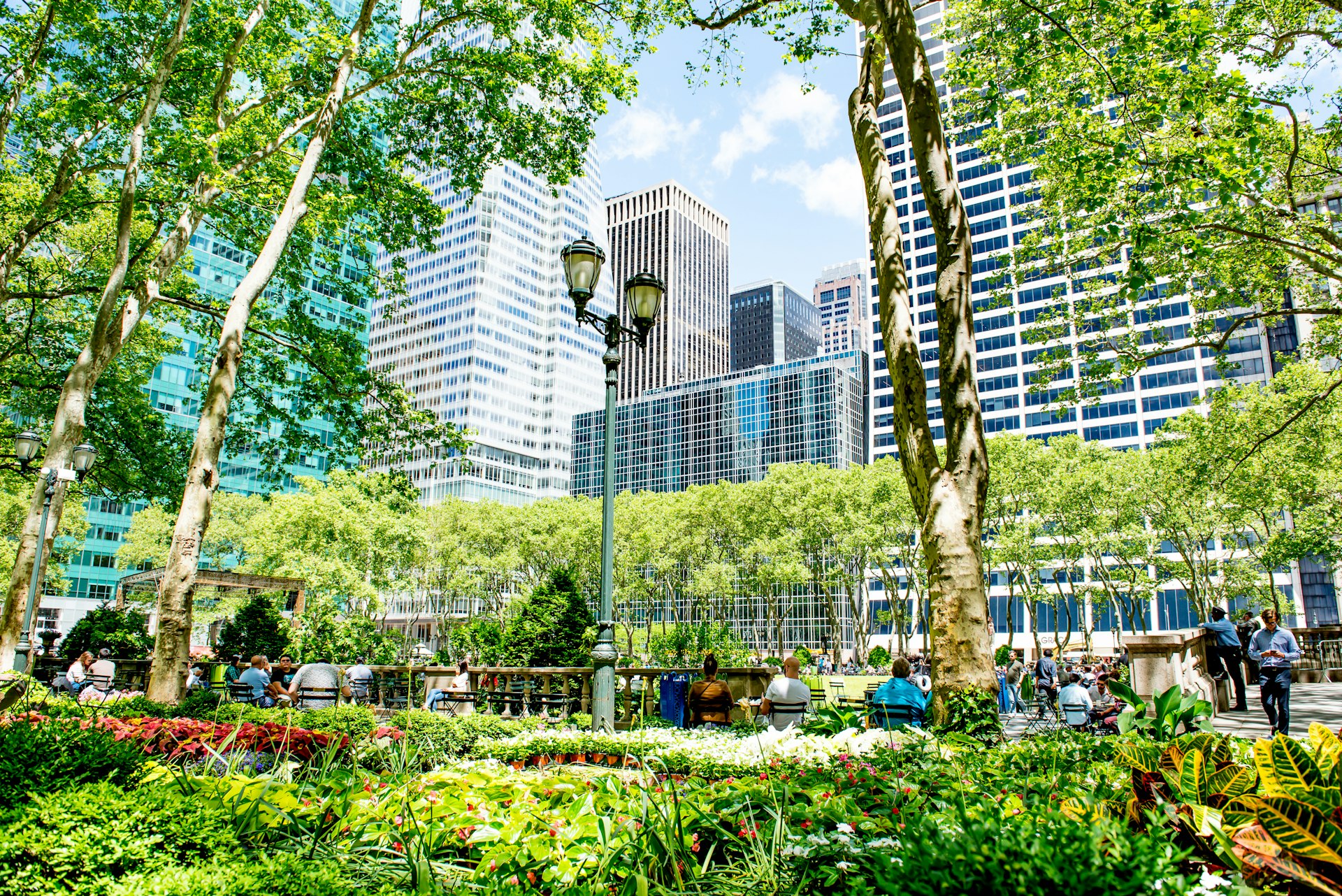 Visitors relax on the grass in Bryant Park 