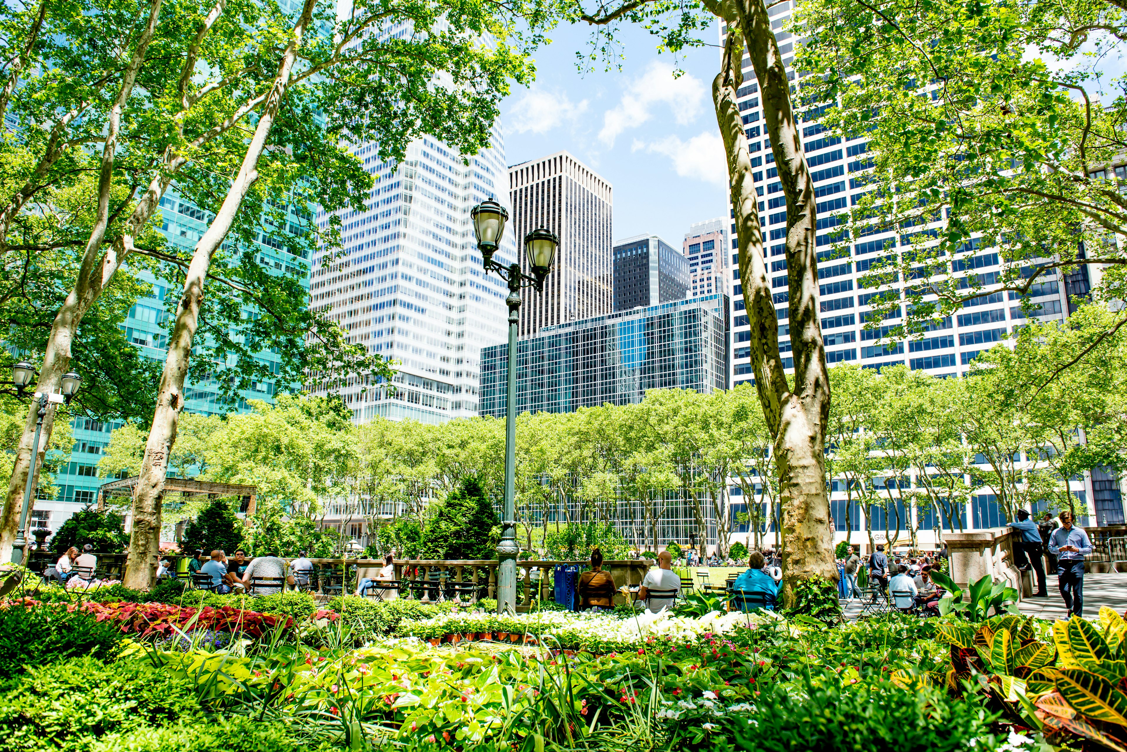 Visitors relax on the grass in Bryant Park