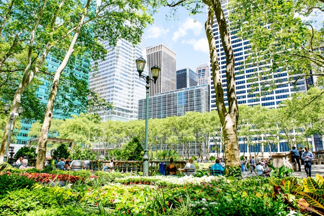 Visitors relax on the grass in Bryant Park
