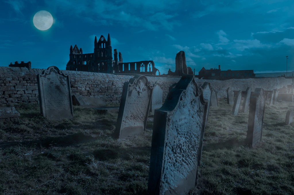 Whitby Abbey at night An atmospheric night-time shot of a ruined abbey with gravestones under a full moon
