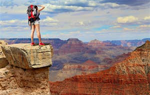 Woman mountain hiker with backpack enjoy view in Grand Canyon.
