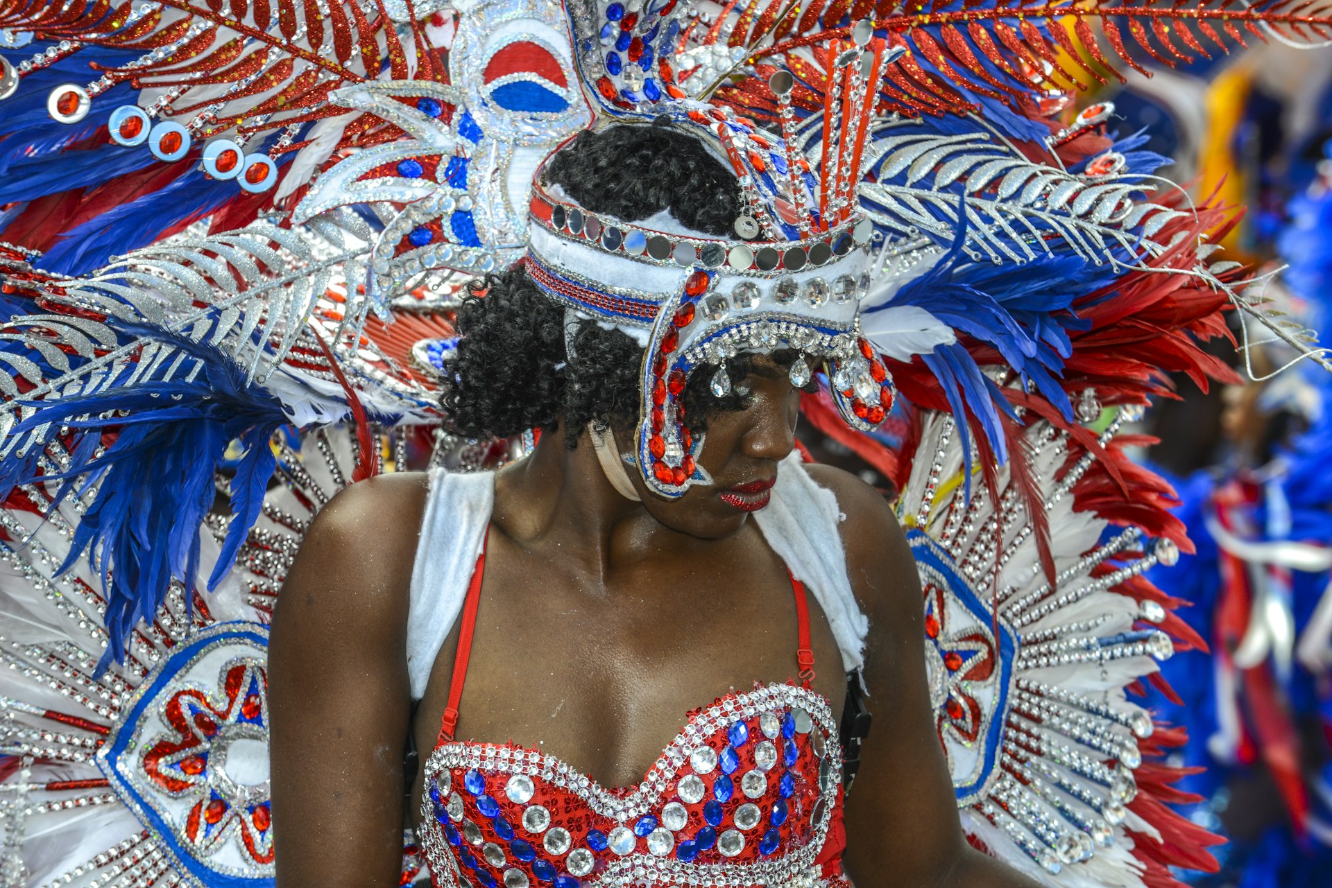 A dancer in traditional colorful red and silver costume at Junkanoo Festival in Nassau, The Bahamas 