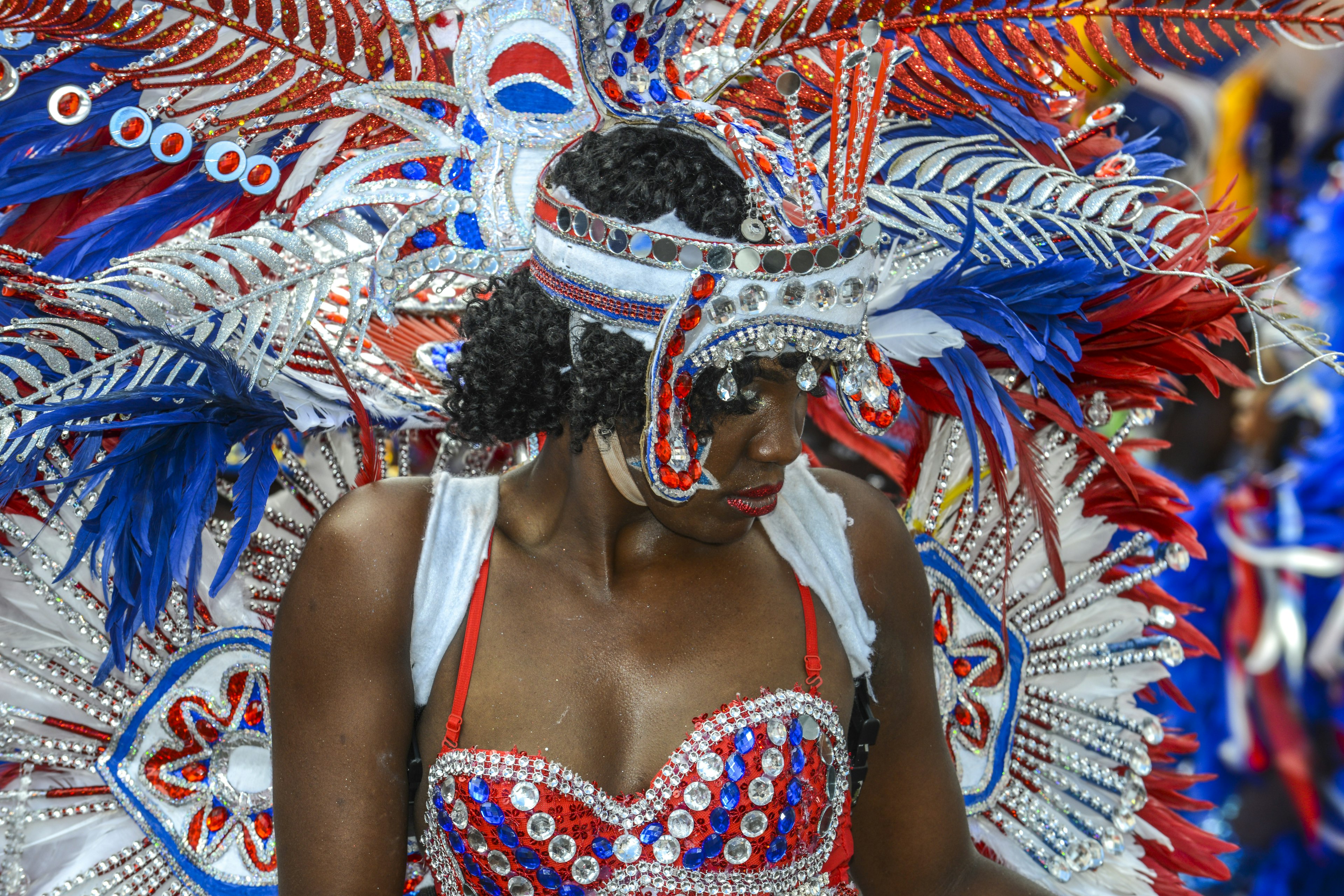 A dancer in traditional colorful red and silver costume at Junkanoo Festival in Nassau, The Bahamas