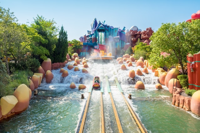 People splash down a log flume at Universal, Florida, on a sunny day.