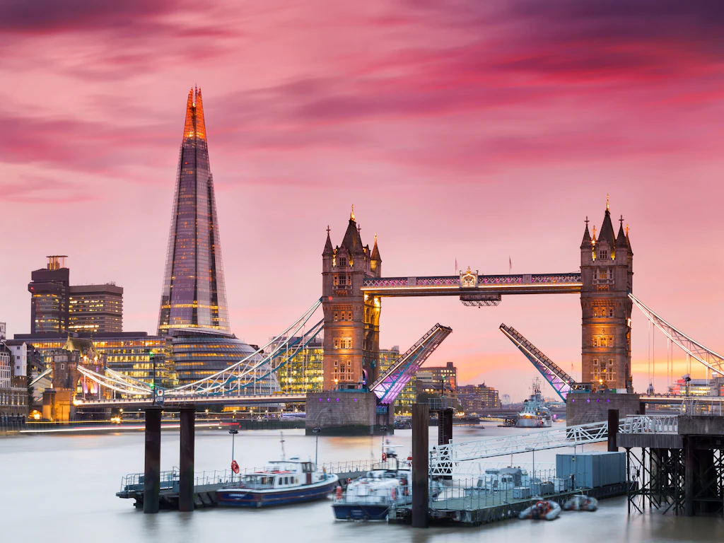 Tower Bridge opening A bridge with two Gothic towers and a roadway opening in the center at sunset