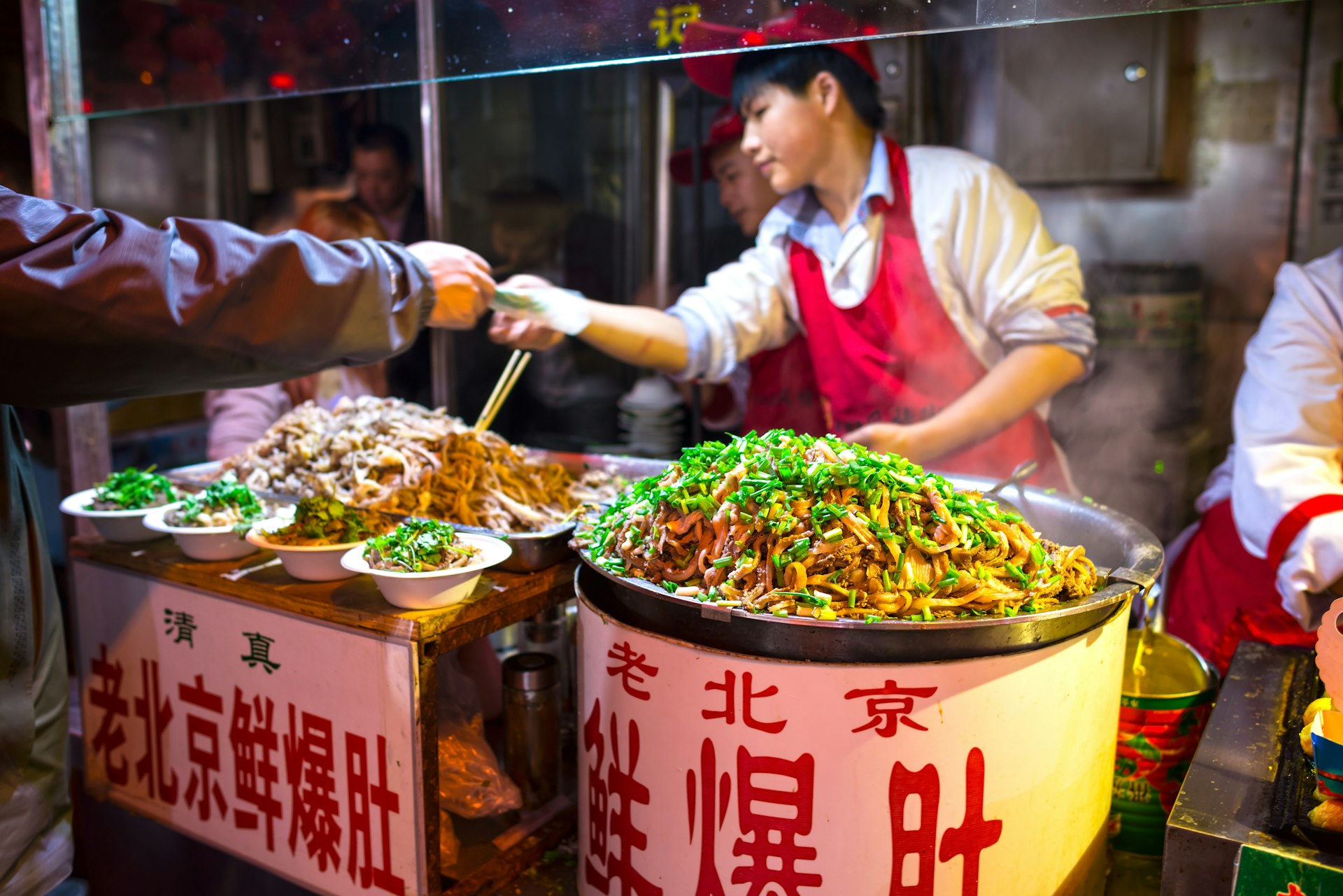 A chef selling pork tripe from a snack food stall on the street.