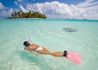 active woman free diving snorkeling in beautiful blue ocean on summer vacation.