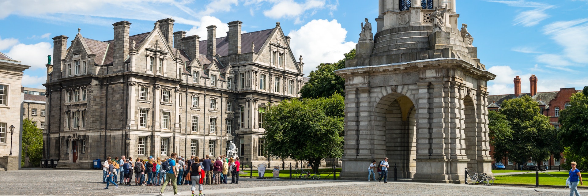 Dublin, Ireland - August 3, 2013: Visitors under the Campanile of the Trinity College