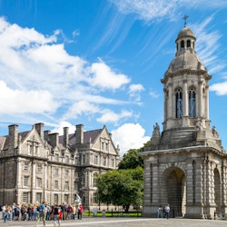 Dublin, Ireland - August 3, 2013: Visitors under the Campanile of the Trinity College