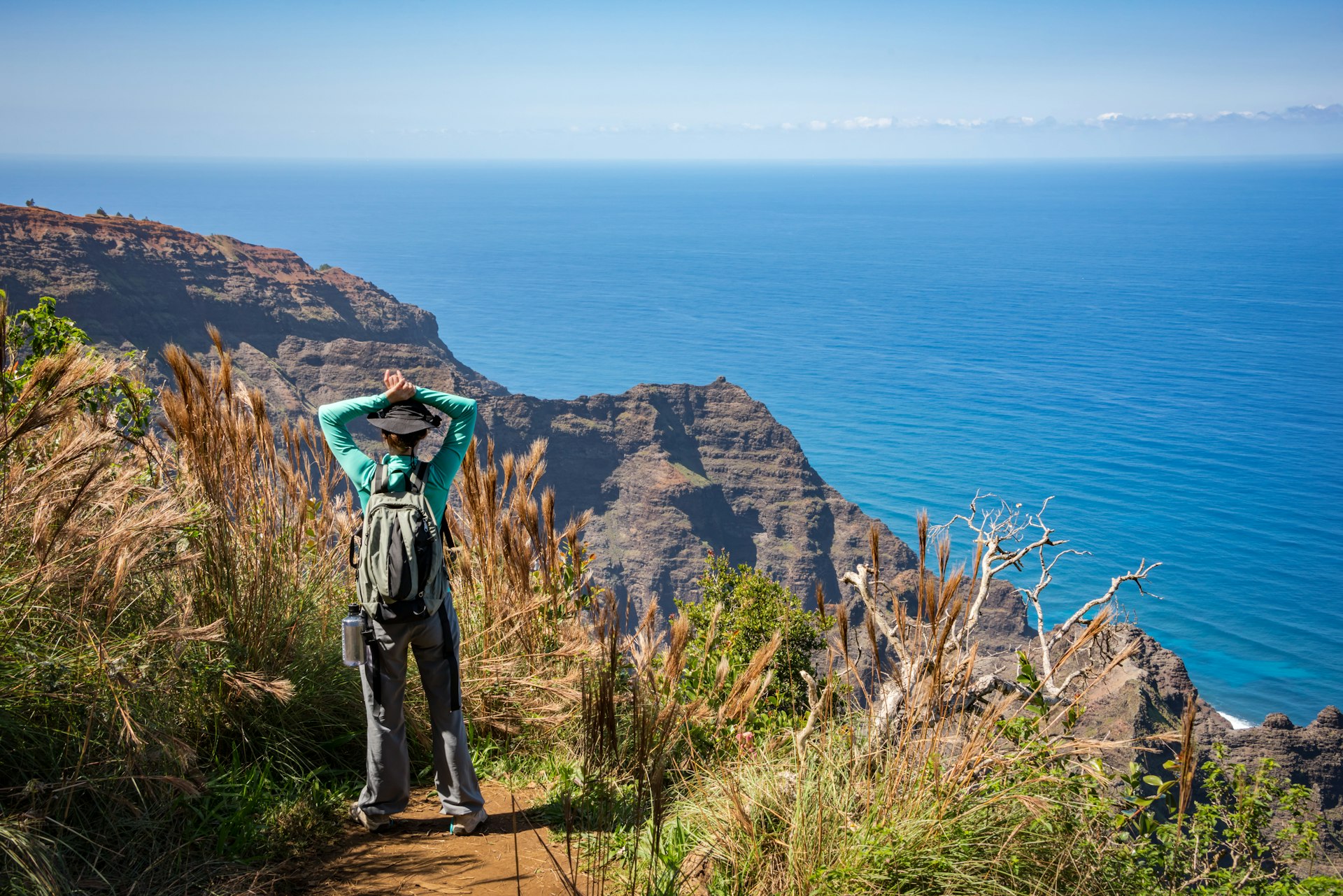 A woman stands at the end of the Awa'awapuhi Trail on Kauai, Hawaii