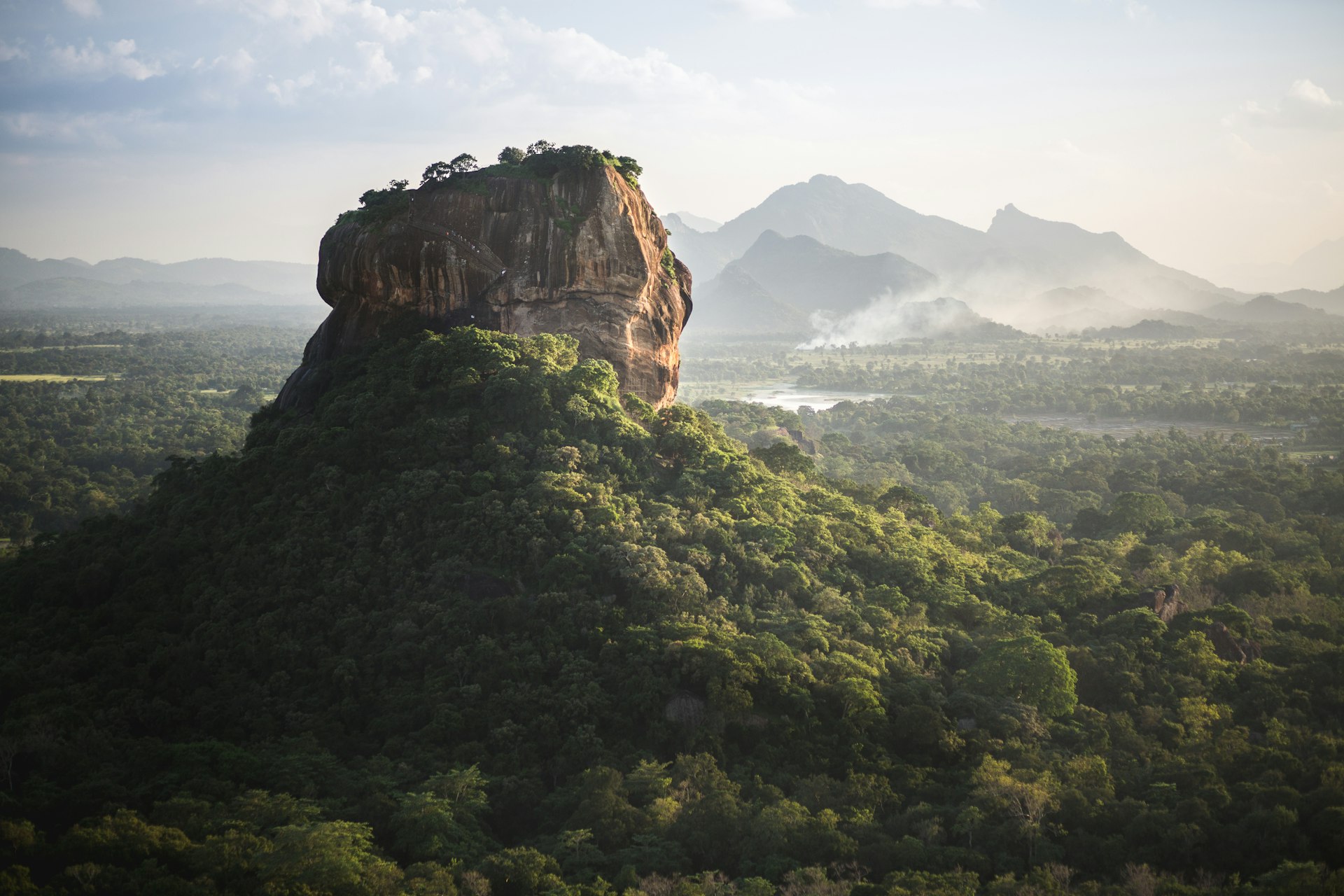 A wide angled view of Sigiriya, a huge rock in Sri Lanka that rises high from flat surrounds in the central region of the country.