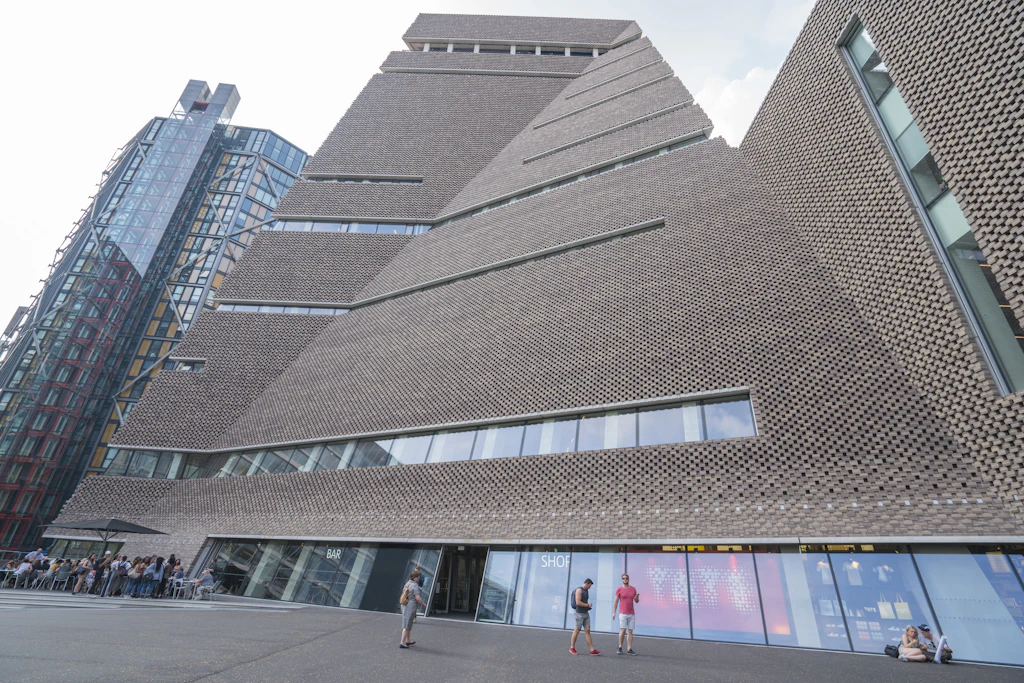 Exterior shot of a large brick building with a angular sections and an unusual brick arrangement