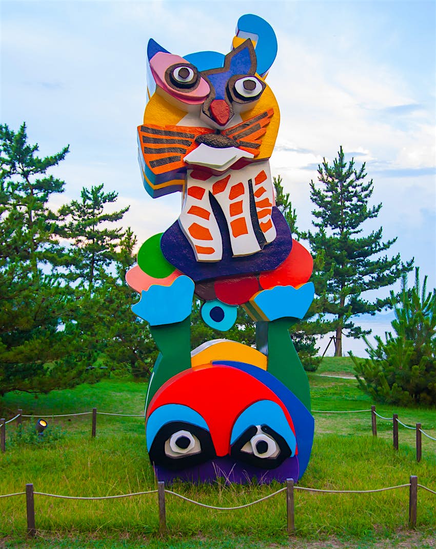 shutterstockRF_491260519_1.jpg An artistic sculpture resembling a large, colourful cat stands in a field on the island of Naoshima, Japan.