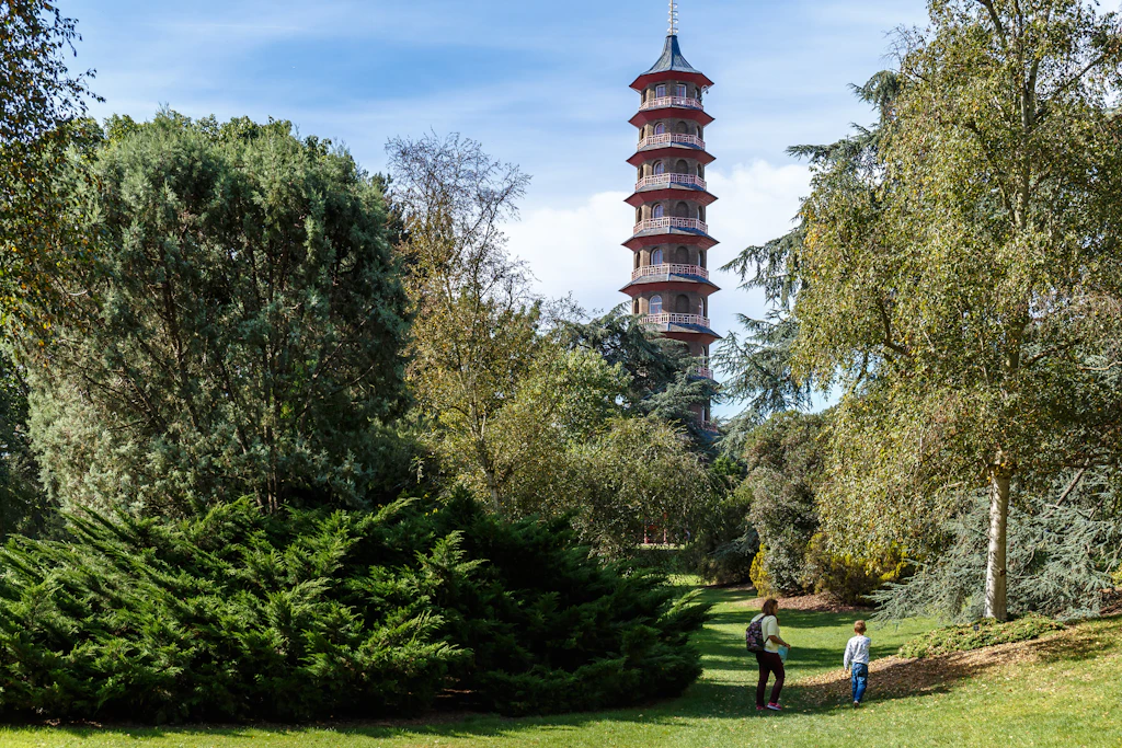 A very tall multi-tiered pagoda-style tower stretches up above treetops