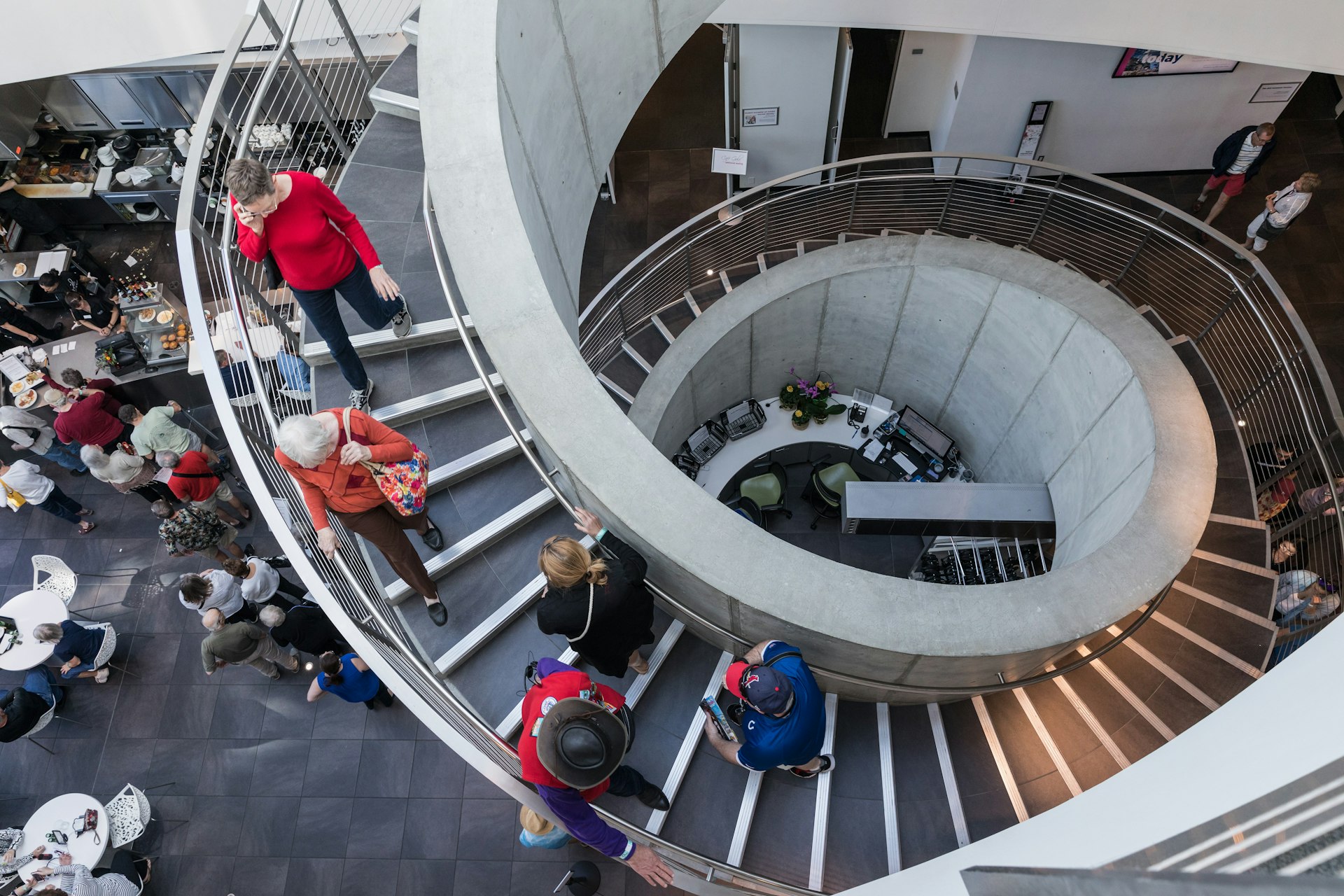 Museum attendees descend a spiral staircase
