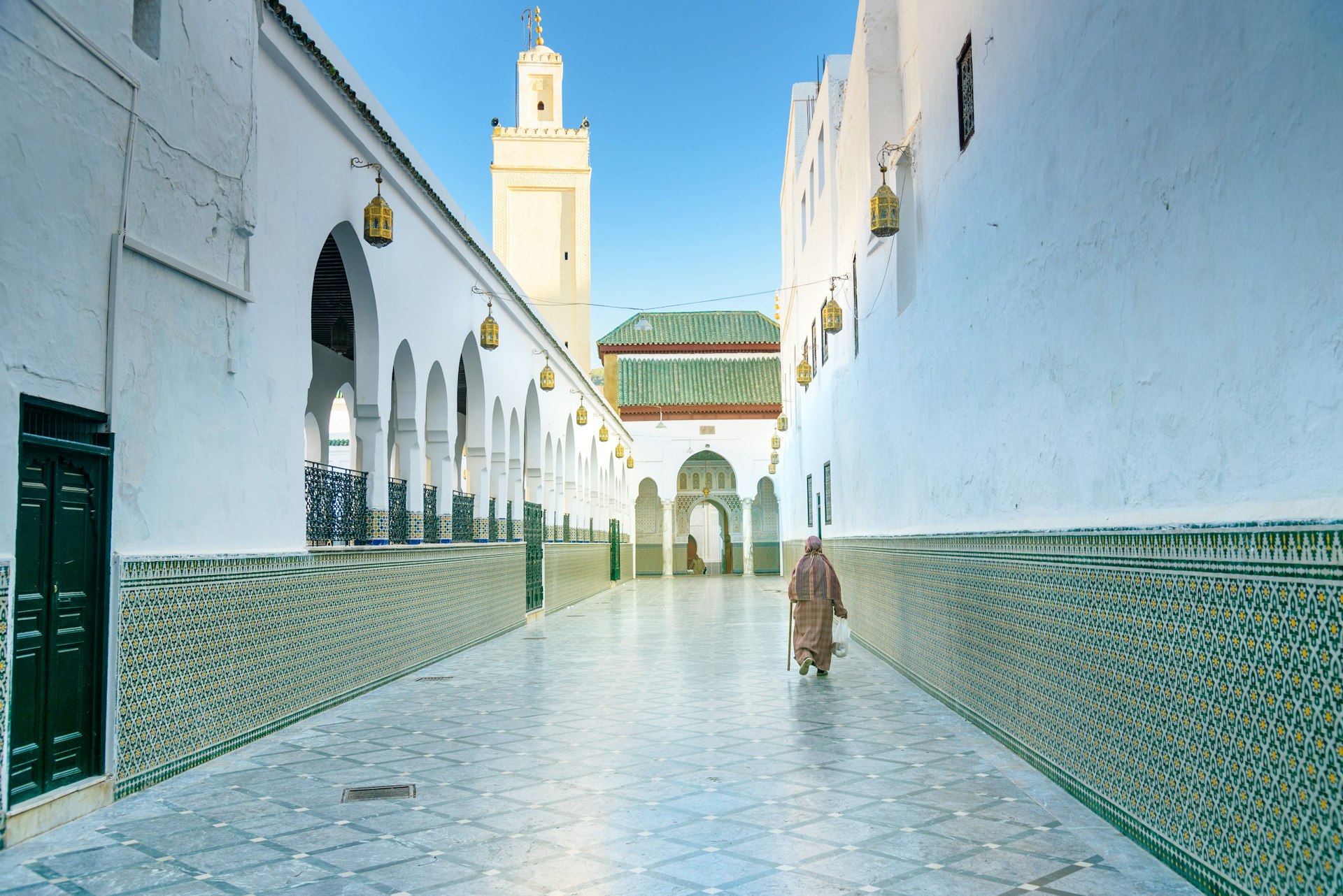 Person walking through narrow alleyway in Moulay Idriss, Morocco