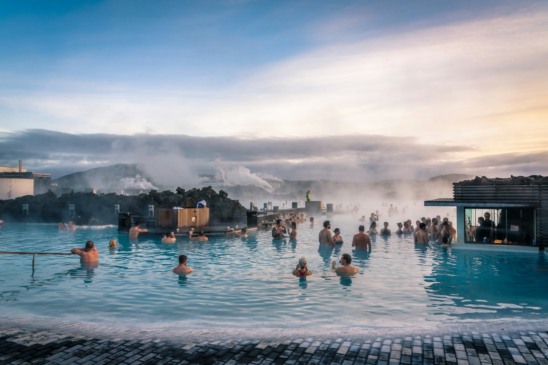 People bathing in the hot waters of Blue Lagoon, a geothermal bath resort