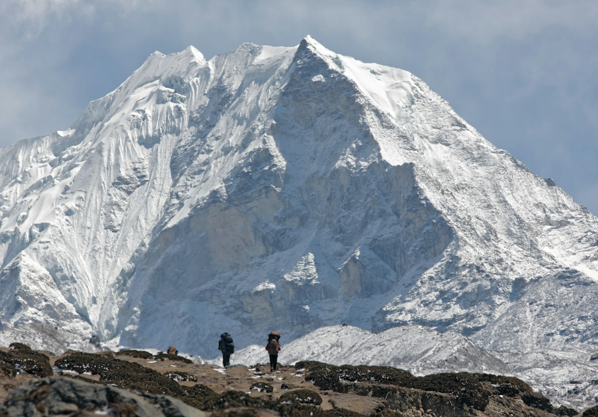 Trekkers against of snow-covered Island peak (6189 m) 