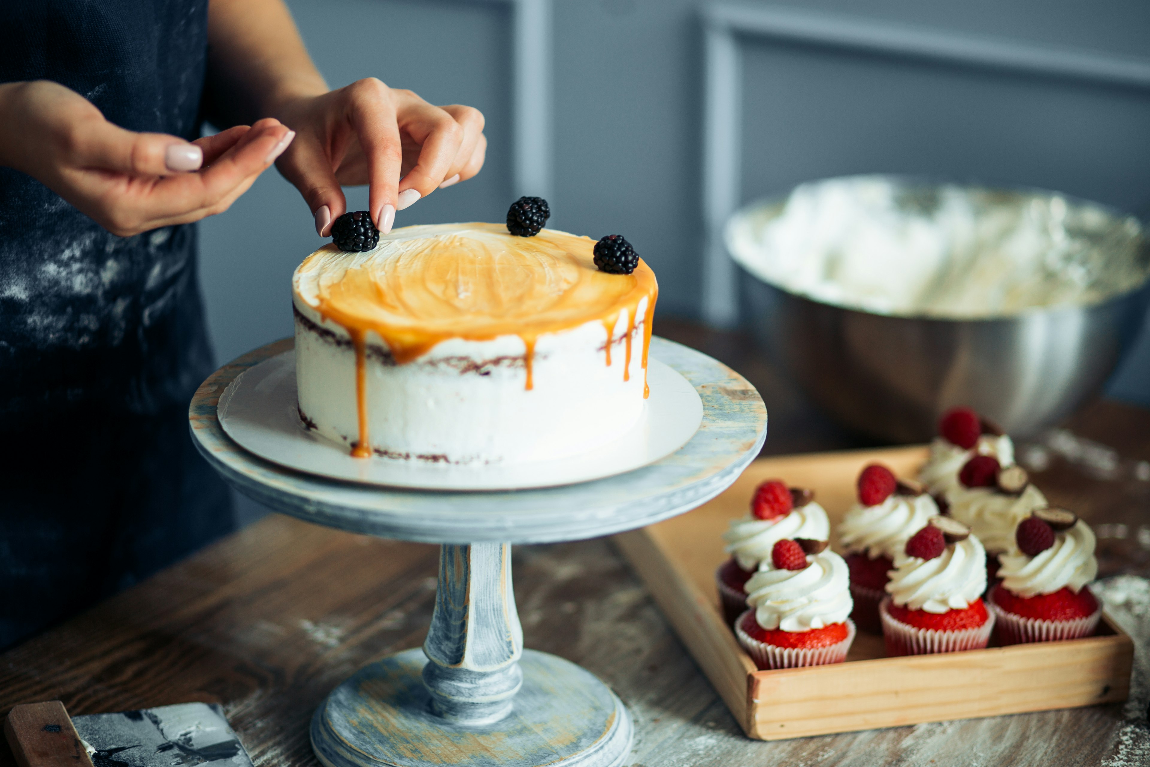 Pastry Chef In The Kitchen Decorating A Cake