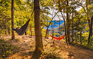 Two hikers hammock along Whitaker Point Trail; Shutterstock ID 1829809304; your: Ben N Buckner; gl: 65050; netsuite: Client Services; full: Arkansas Outdoor Adventures