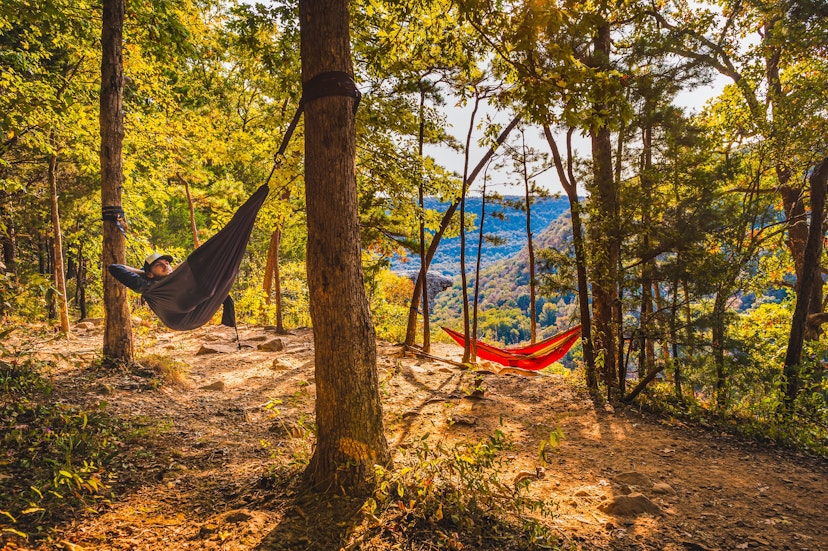 Two hikers hammock along Whitaker Point Trail; Shutterstock ID 1829809304; your: Ben N Buckner; gl: 65050; netsuite: Client Services; full: Arkansas Outdoor Adventures