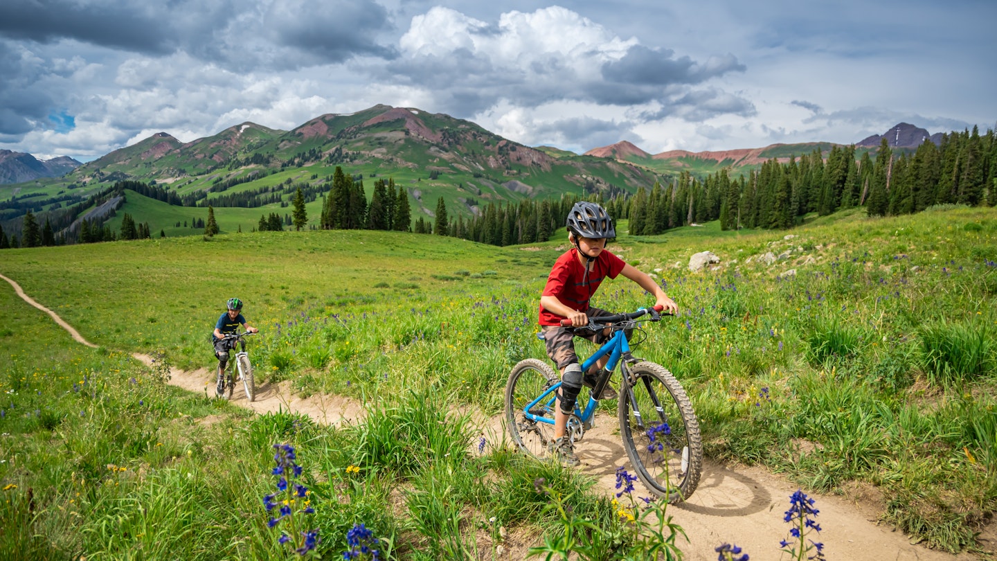 A modern family of bikers, riding on bicycles in Crested Butte, Colorado.
