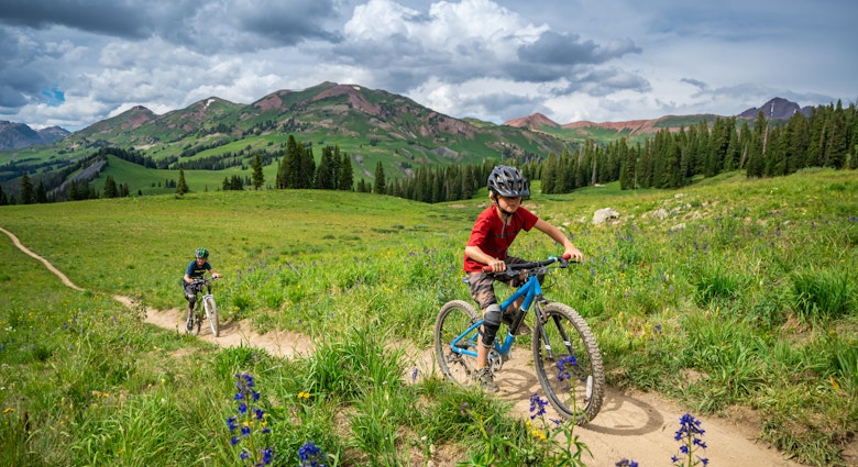 A modern family of bikers, riding on bicycles in Crested Butte, Colorado.