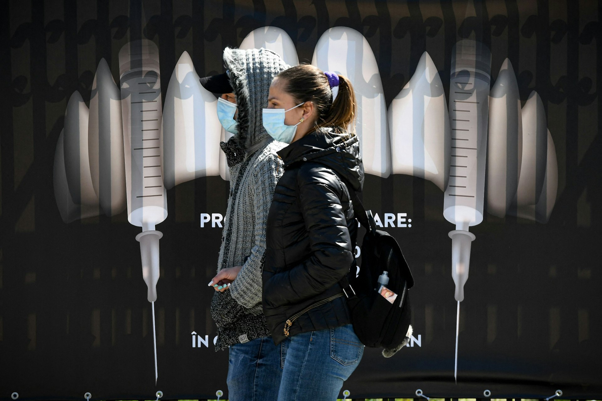 People wearing facemasks at the vaccination center at Bran Castle in Romania