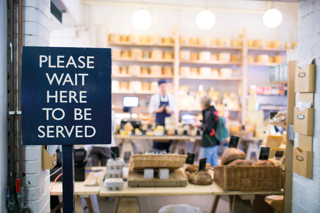 Neal's Yard Dairy, Borough Market A cheesemongers with a large sign reading "Please wait here to be served"