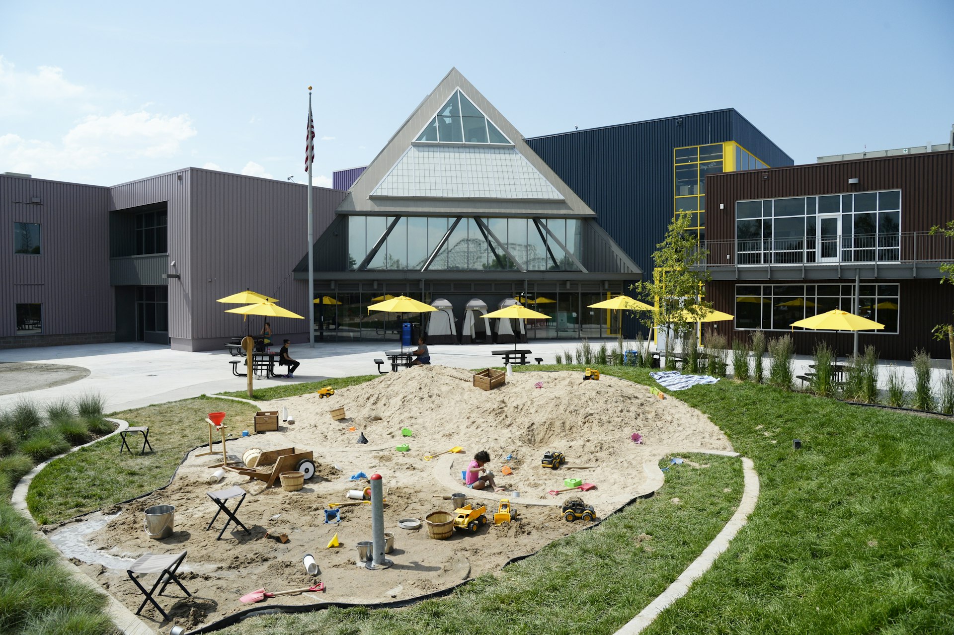 A child plays in the sand area of Joy Park at the Denver Children's Museum in Denver, Colorado.