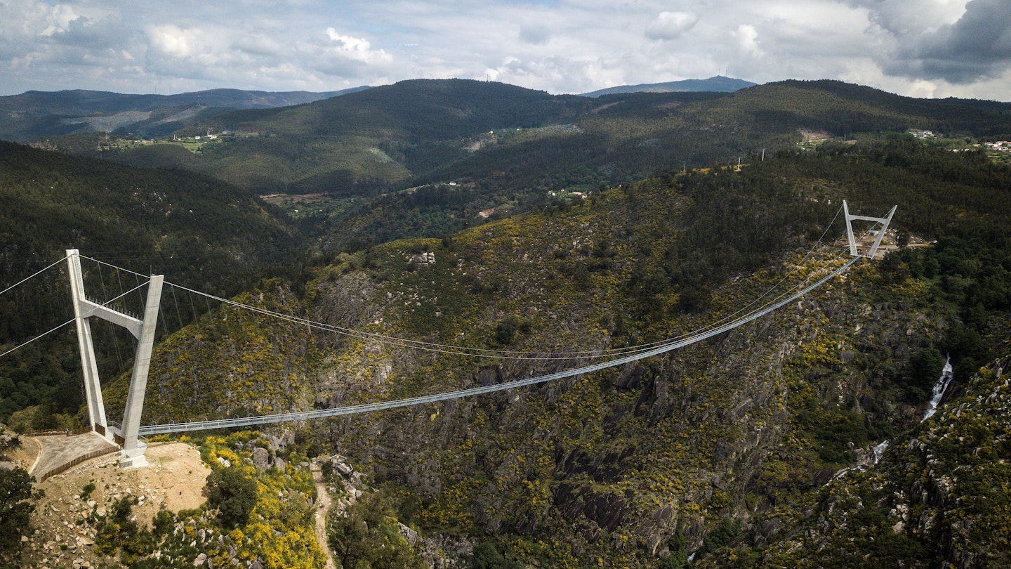 An aerial view shows the 516 Arouca Bridge, the world's longest pedestrian suspension bridge with a length of 516 metres and a height of 175 metres, in Arouca in northern Portugal on April 29, 2021. (Photo by CARLOS COSTA / AFP) (Photo by CARLOS COSTA/AFP via Getty Images)