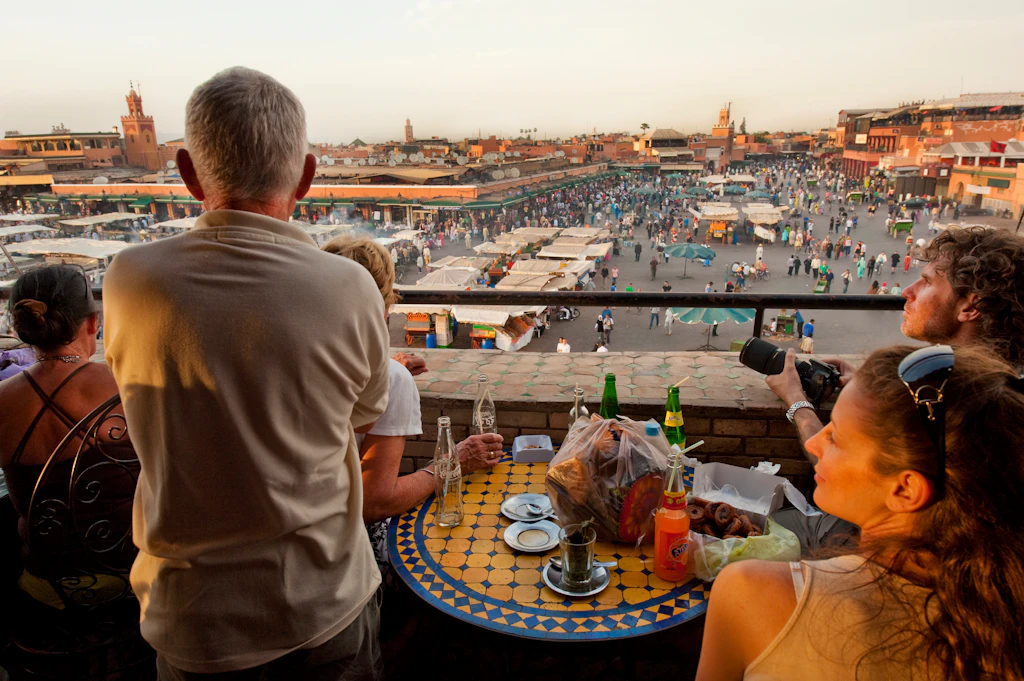 Visitors at a terrace above Djemaa El Fna square in Marrakesh, Morocco Visitors at a terrace above Djemaa El Fna square in Marrakesh, Morocco