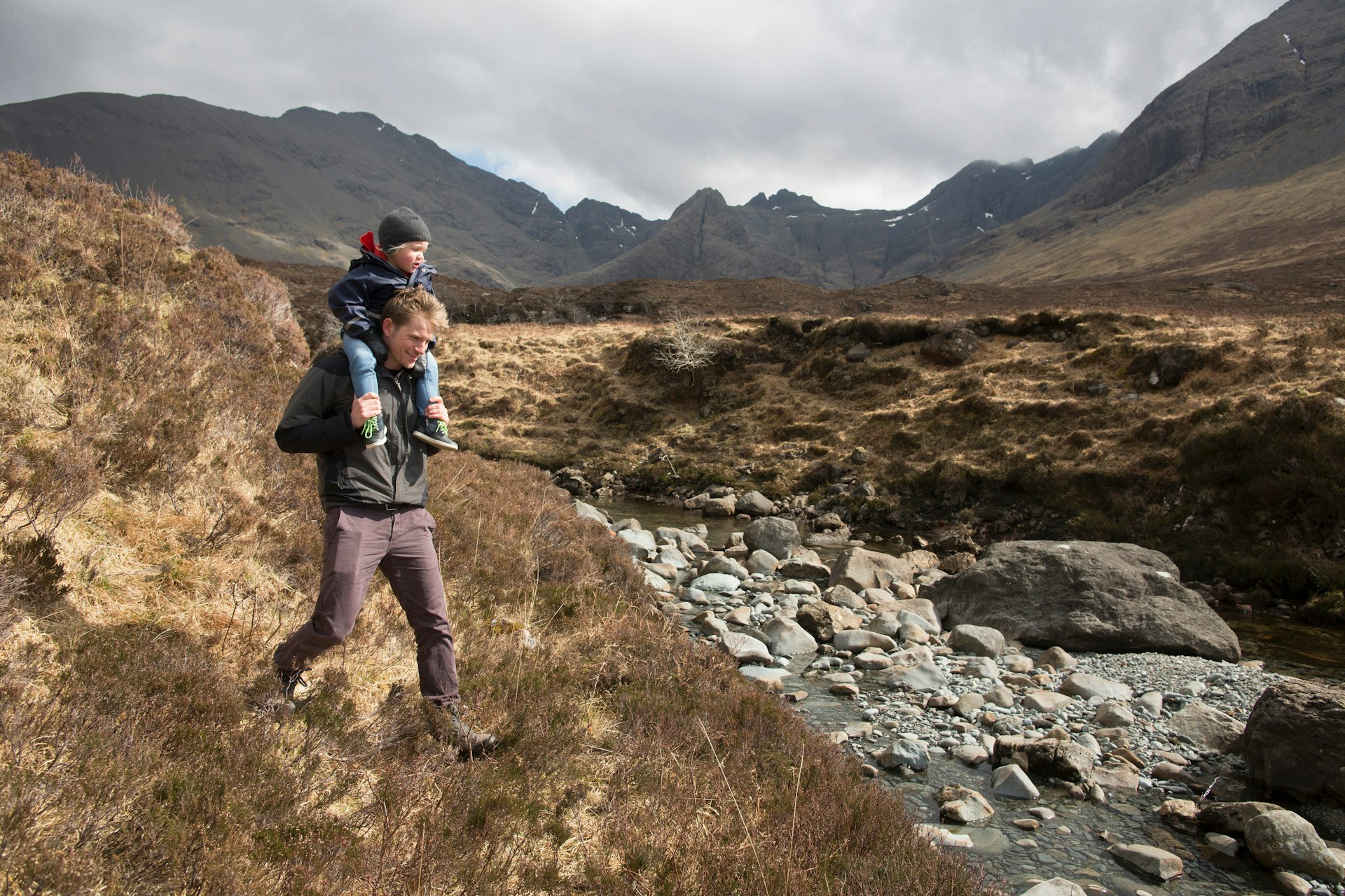 Father and son hiking, Fairy Pools, Isle of Skye, Hebrides, Scotland