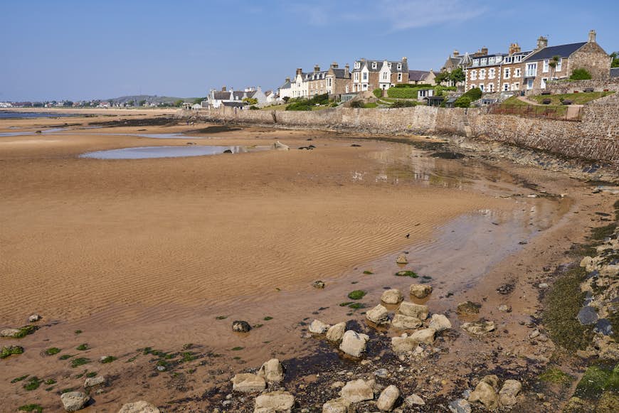 A golden sandy beach backed with Victorian residential properties