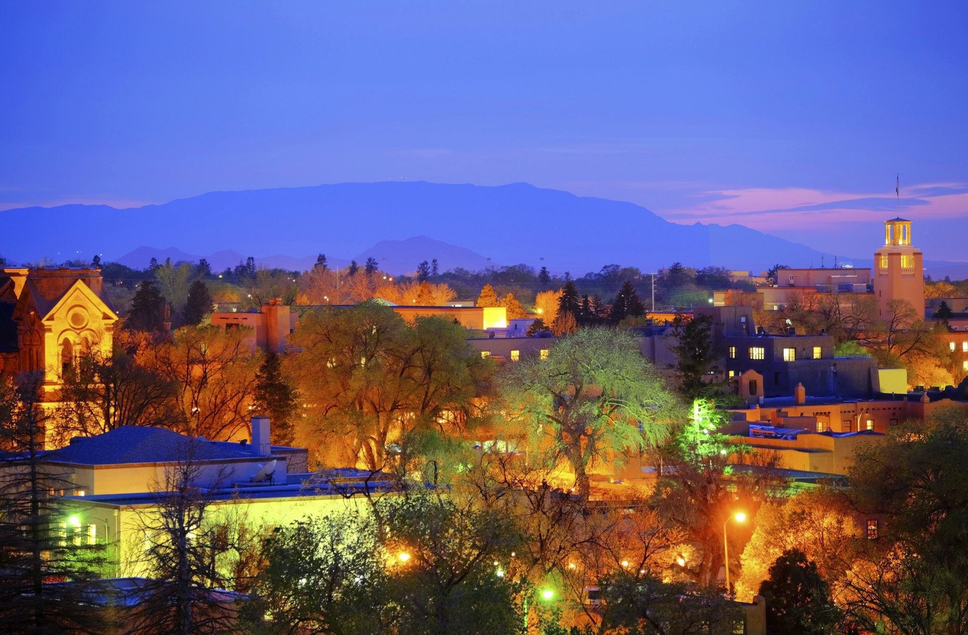 The lights come on as the sun sets over downtown Santa Fe