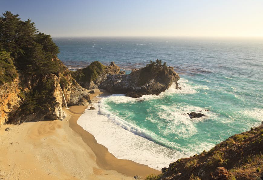 A wide angle view of McWay Falls in late afternoon in Julia Pfeiffer Burns State Park in the Big Sur area of Central California