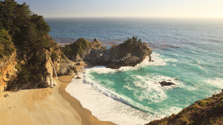 A wide angle view of McWay Falls in late afternoon in Julia Pfeiffer Burns State Park in the Big Sur area of Central California