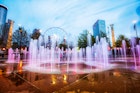 April 5, 2014: The colourfully lit fountain at Centennial Olympic Park with a Ferris wheel in the background.