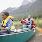 Father and daughter canoeing in a lake.