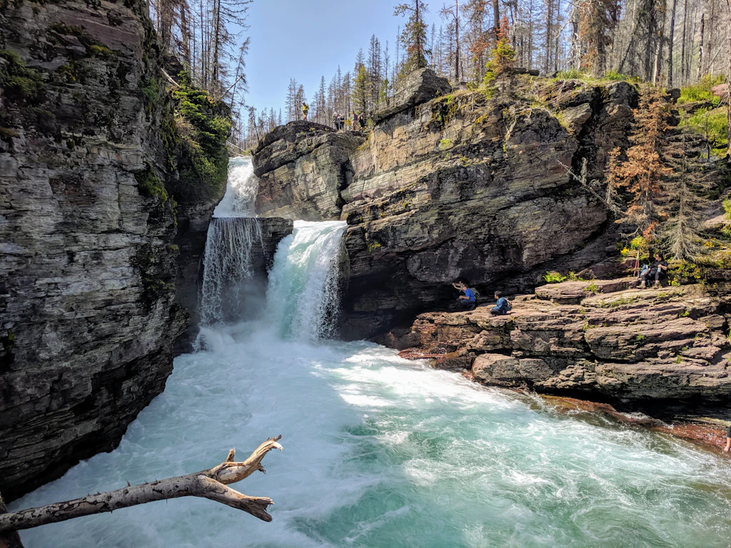 IMG_20190706_143747.jpg A turquoise cascade falls over rocks twice at St Mary's Falls in Glacier National Park
